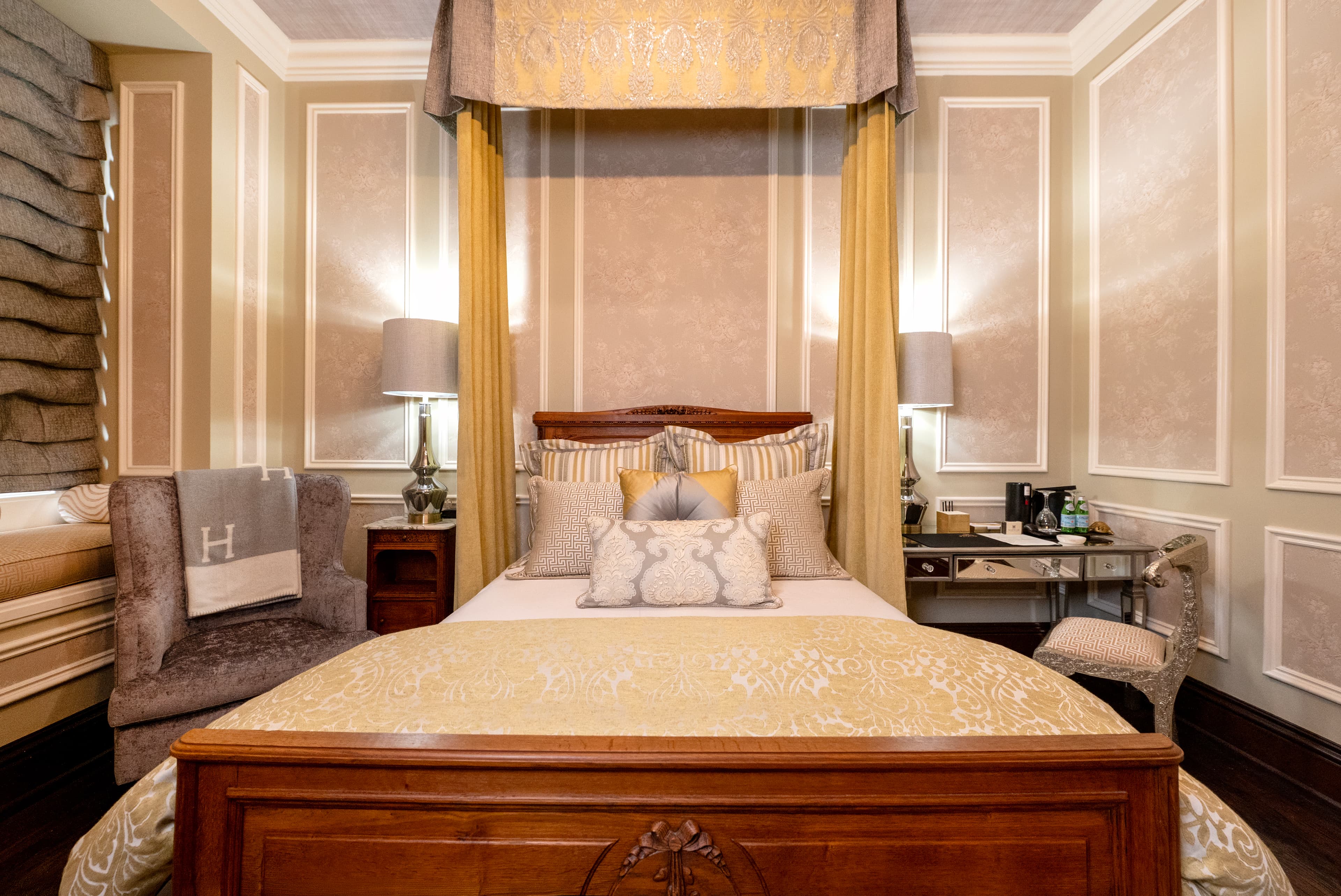 A canopied guest bed in a restored Wheeler Mansion suite